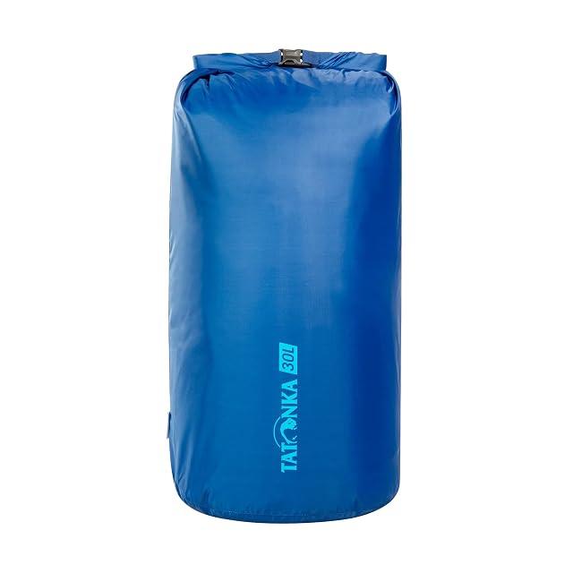 Tatonka blue Dry Sack rolled closed with its clip buckle