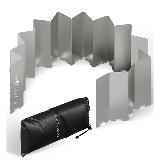 EVOCAMP folding windshield standing around a camping stove, with its carry bag